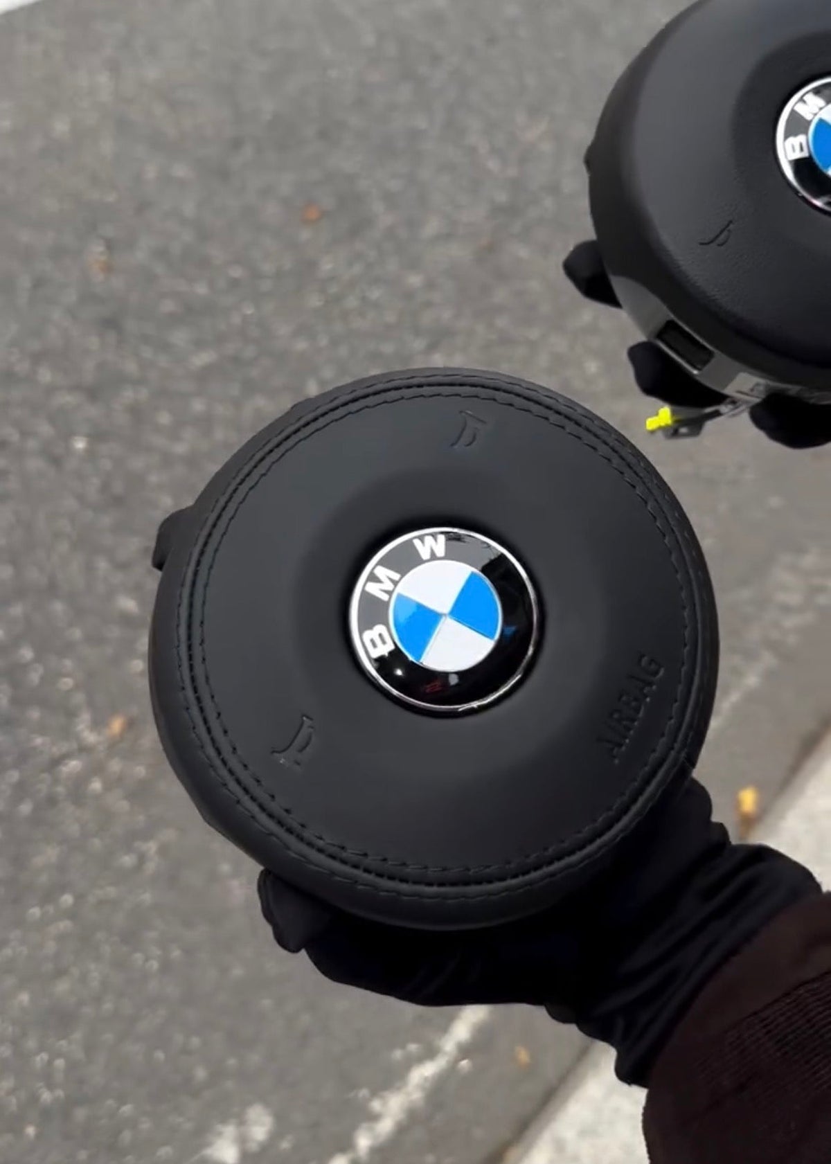 BMW F-Series Leather OEM Airbag - held angle view