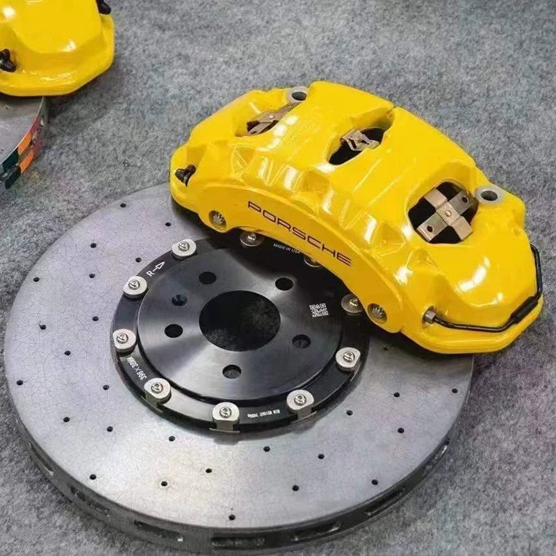 Yellow Porsche brake caliper on drilled carbon ceramic disc for Porsche Macan