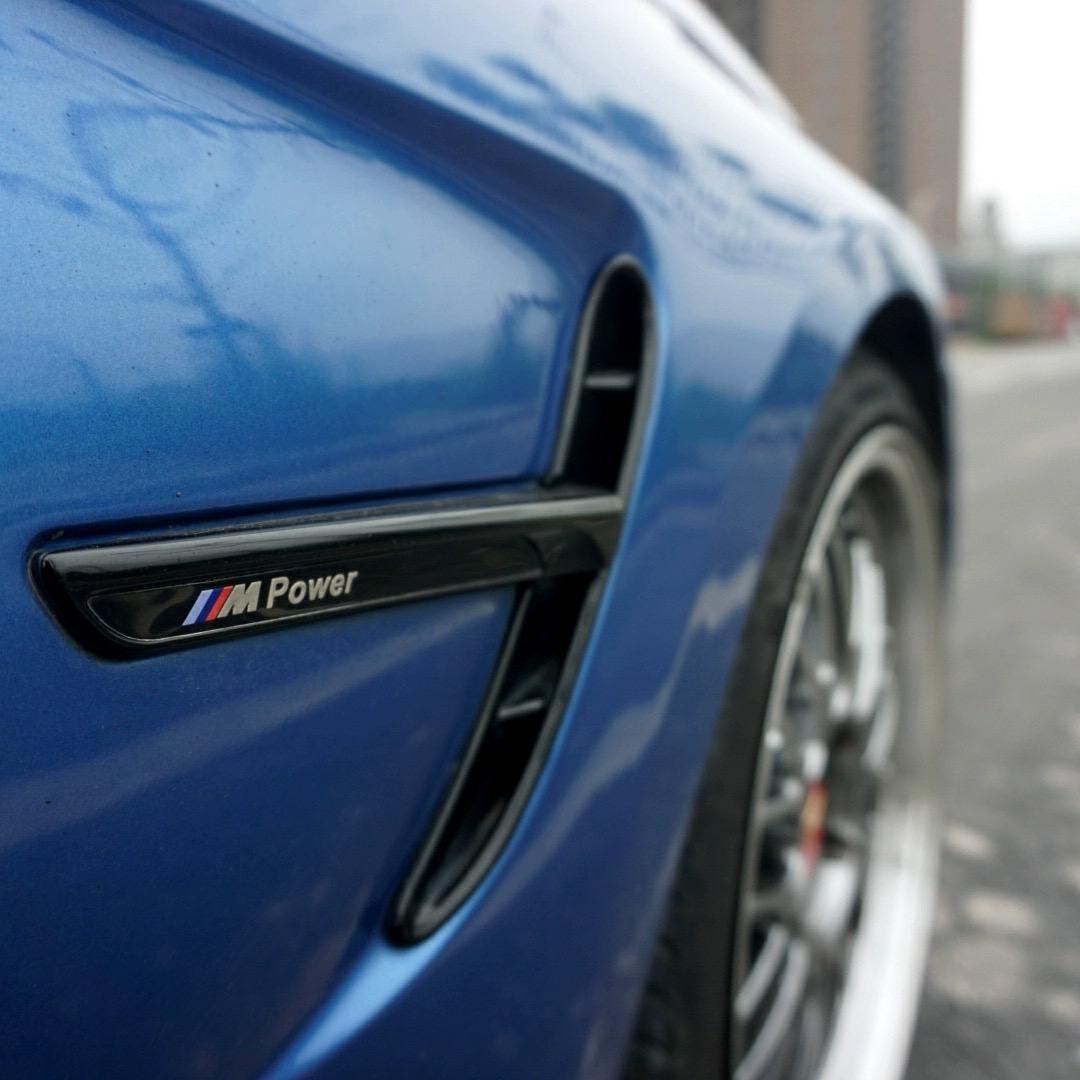BMW 3 Series fender side vent installed on blue car body