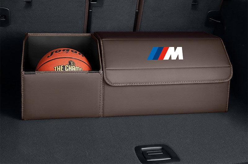 BMW trunk storage box open with basketball and items inside, brown leather finish