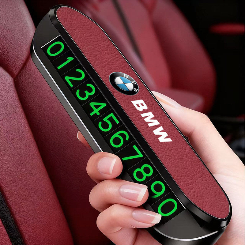 BMW illuminated parking number plate glowing on black interior trim