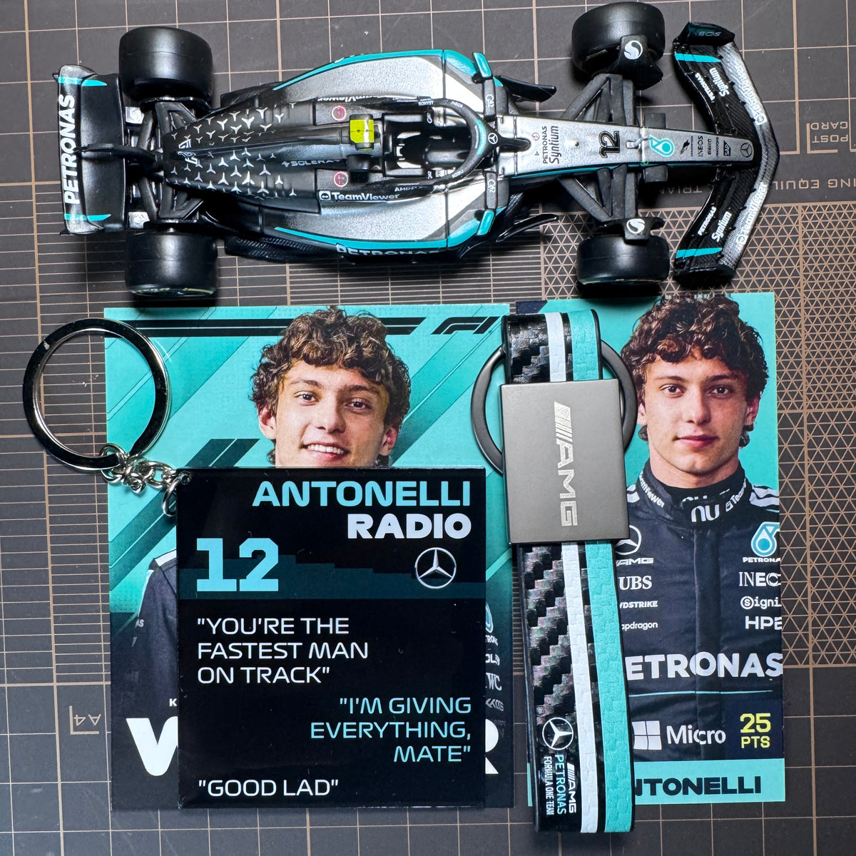 Miniature Mercedes-AMG F1 car keychain with Antonelli radio pendant and strap