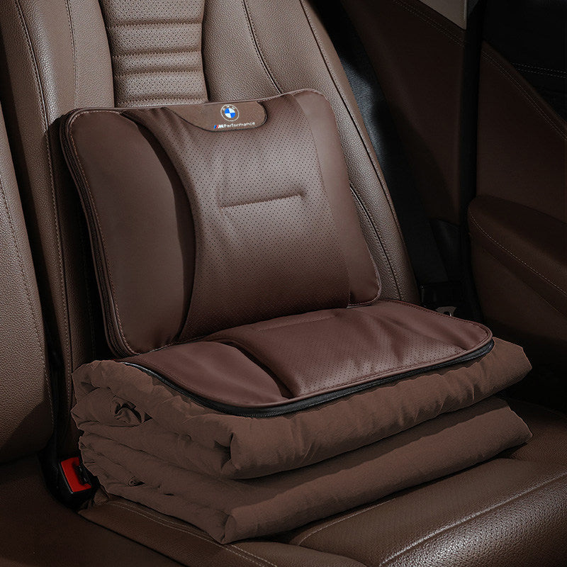 BMW lumbar pillow and folded blanket set on rear car seat