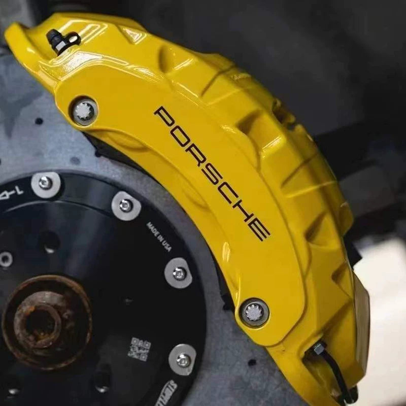 Close-up of yellow Porsche lettered caliper and carbon ceramic disc