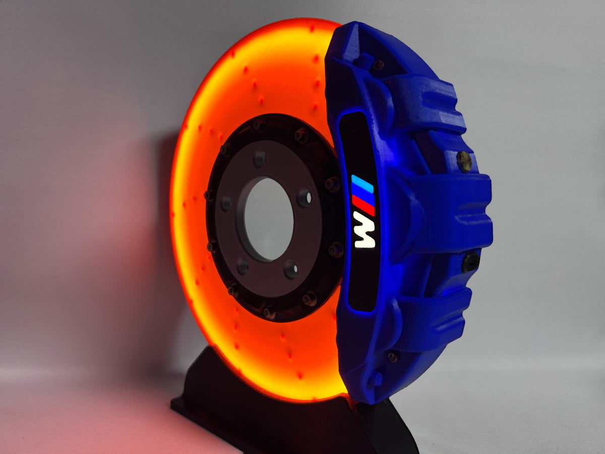 BMW M brake disc LED night light, blue caliper, close-up side view