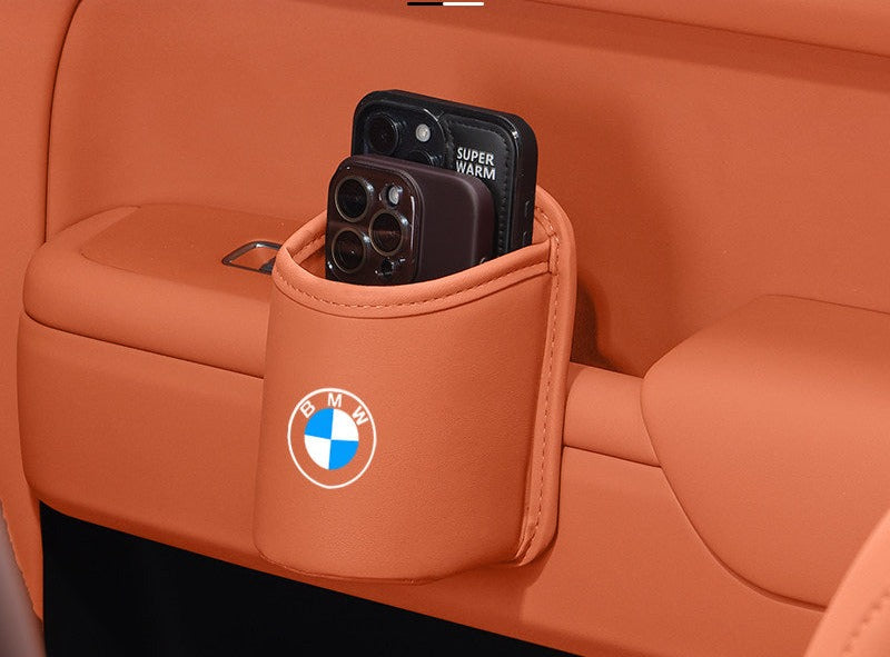 BMW leather car storage pocket holding phone and cup, orange