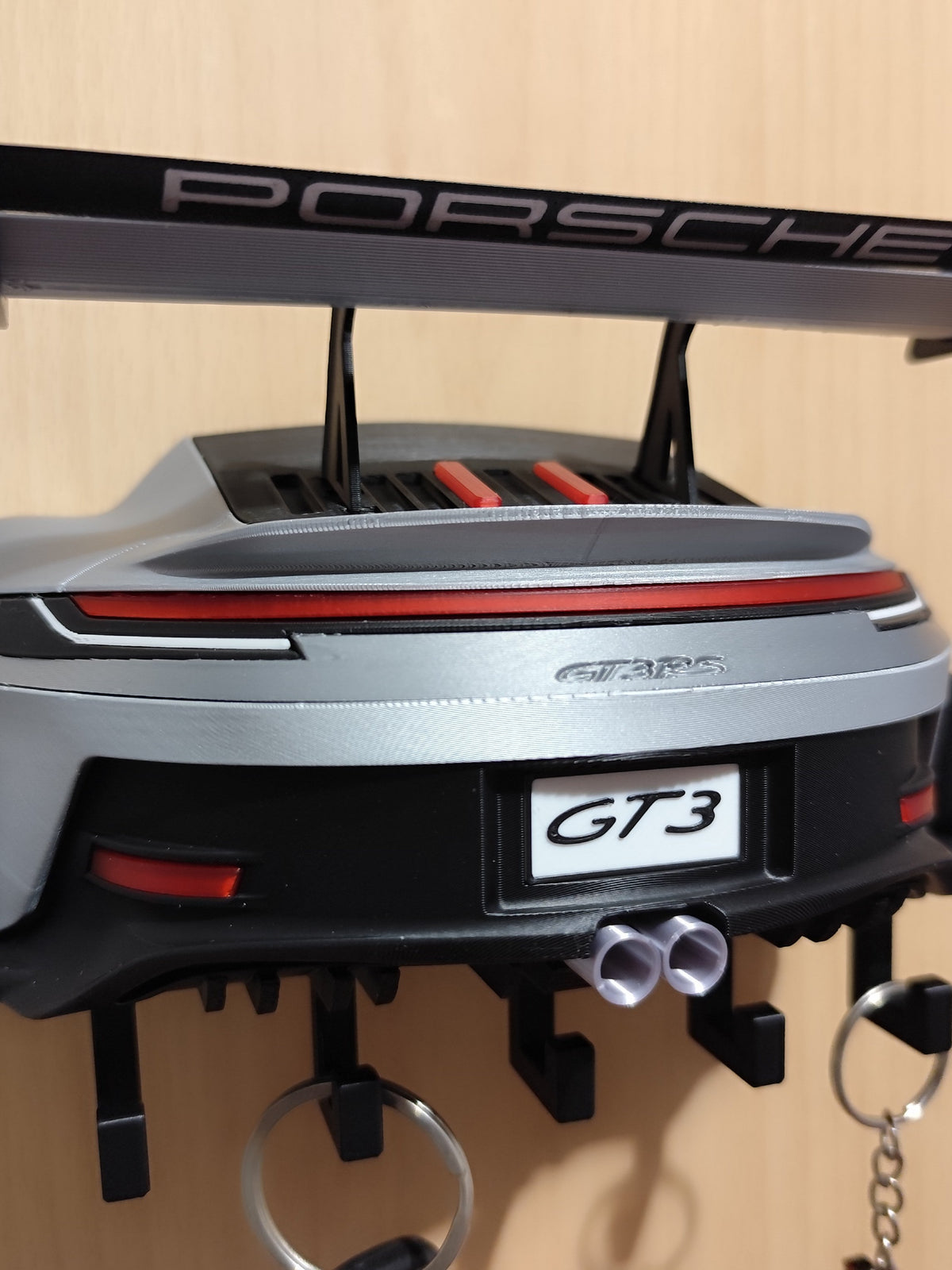 Close-up of the Porsche rear wing and GT3 plate on the key holder