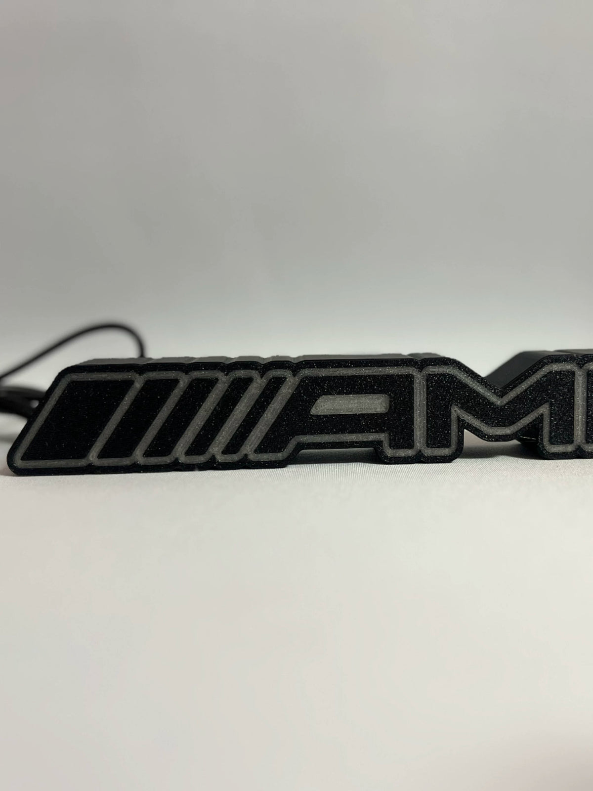 Mercedes-AMG emblem lamp textured black 3D-printed body