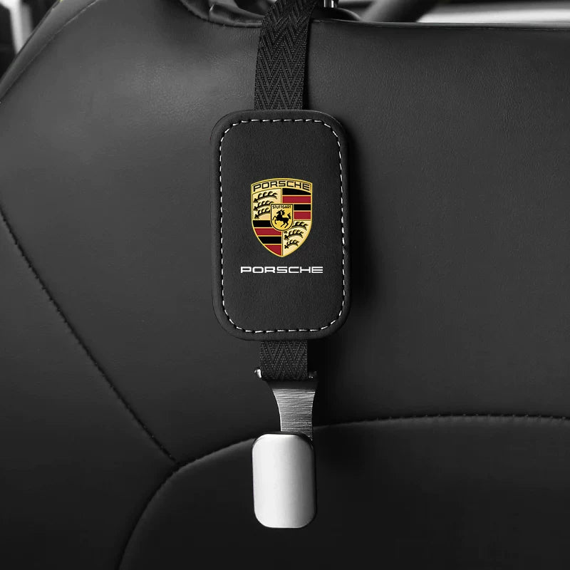 Black Porsche suede seat back hook, single, on a headrest