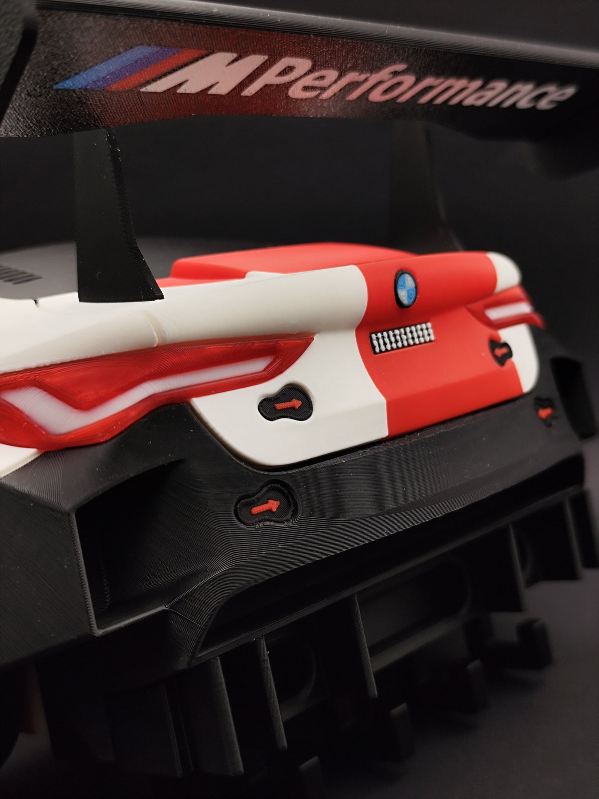 BMW M4 GT3 wall key holder close-up of rear diffuser and taillights