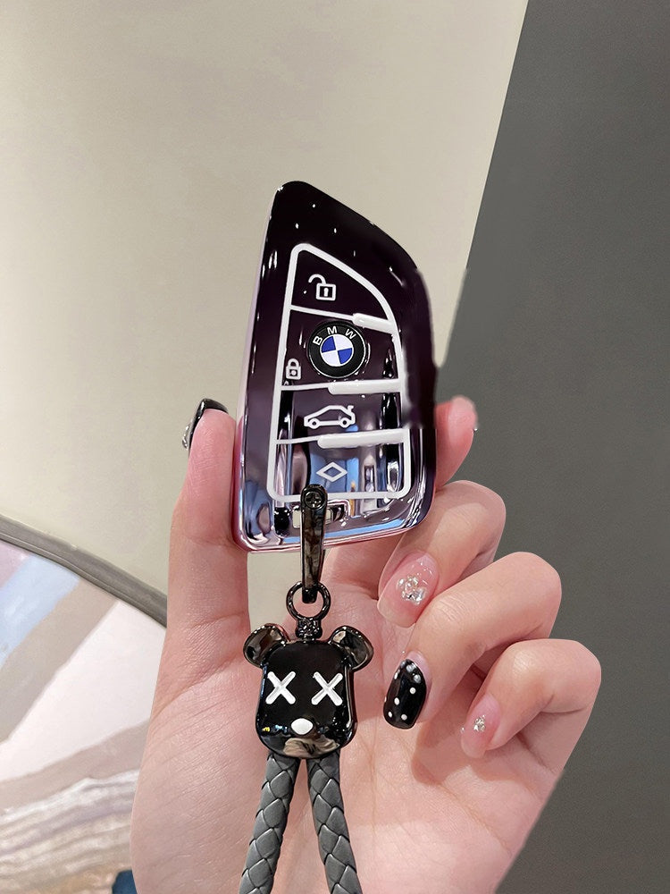 BMW smart key starry sky black TPU sleeve with bear keychain, side angle