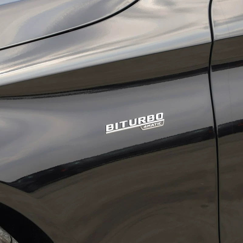 Mercedes-AMG BITURBO 4MATIC fender badge fitted on a black Mercedes-Benz