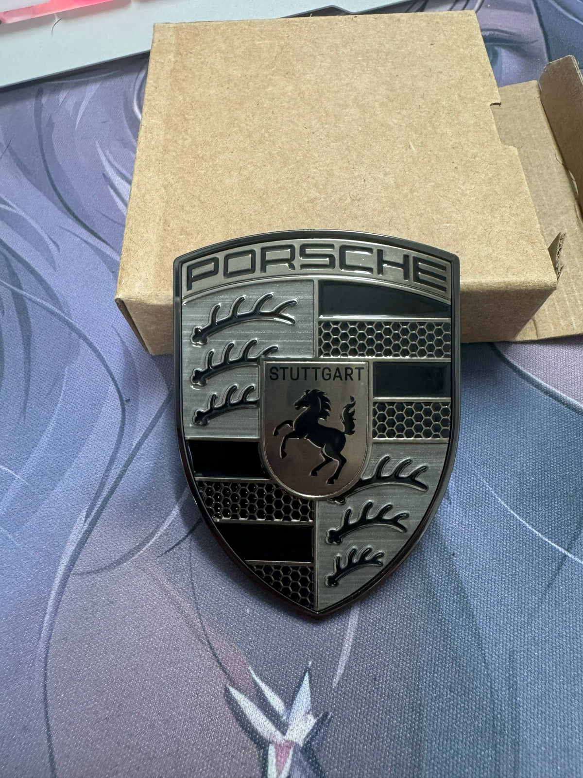 Porsche smoked gray crest hood badge – brushed metal and black enamel finish