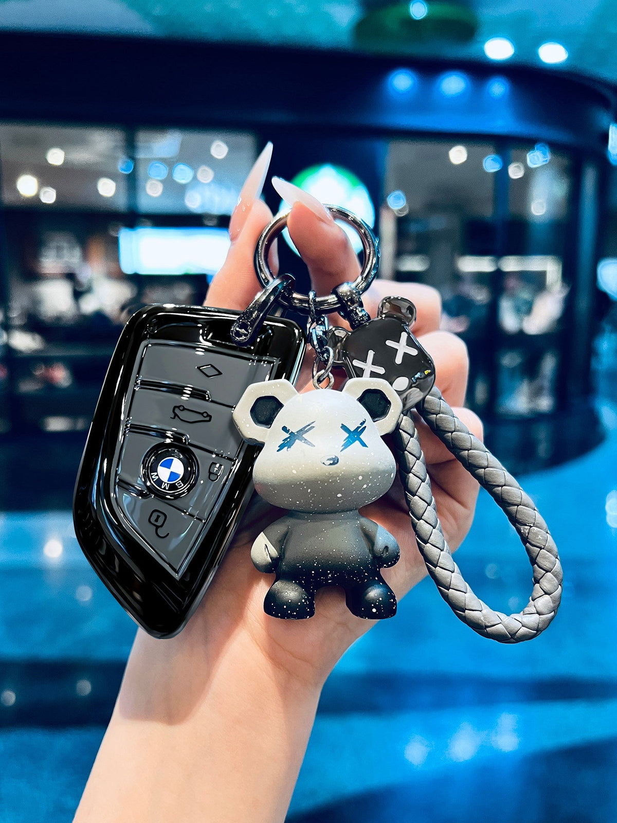 BMW glossy black TPU key sleeve with bear keychain, side view