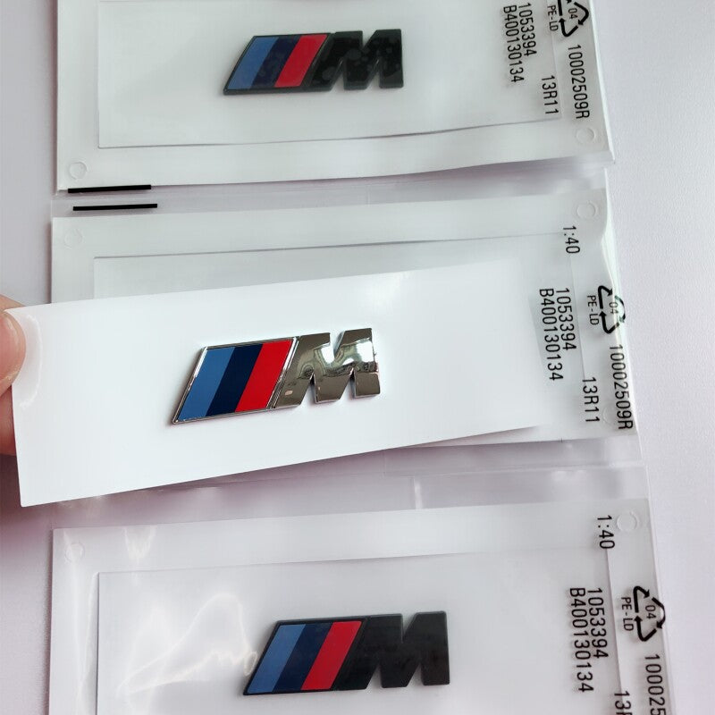 BMW M side badge packaging with silver and black versions
