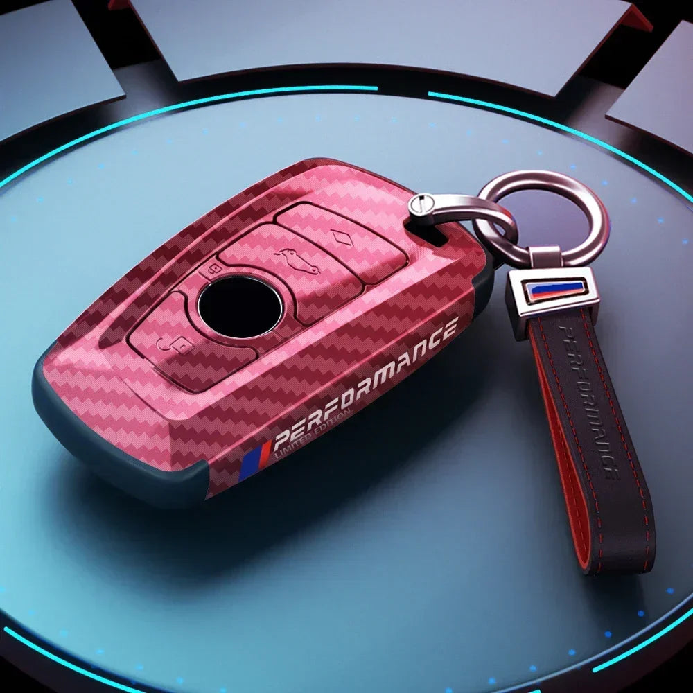 BMW red carbon fiber key case with M Performance keychain, close-up
