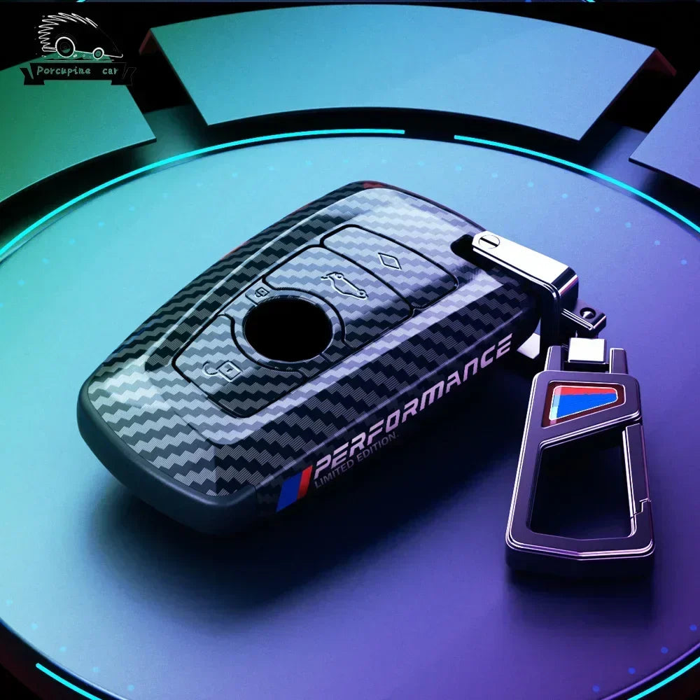 BMW carbon fiber key case with blue keychain, alternate angle