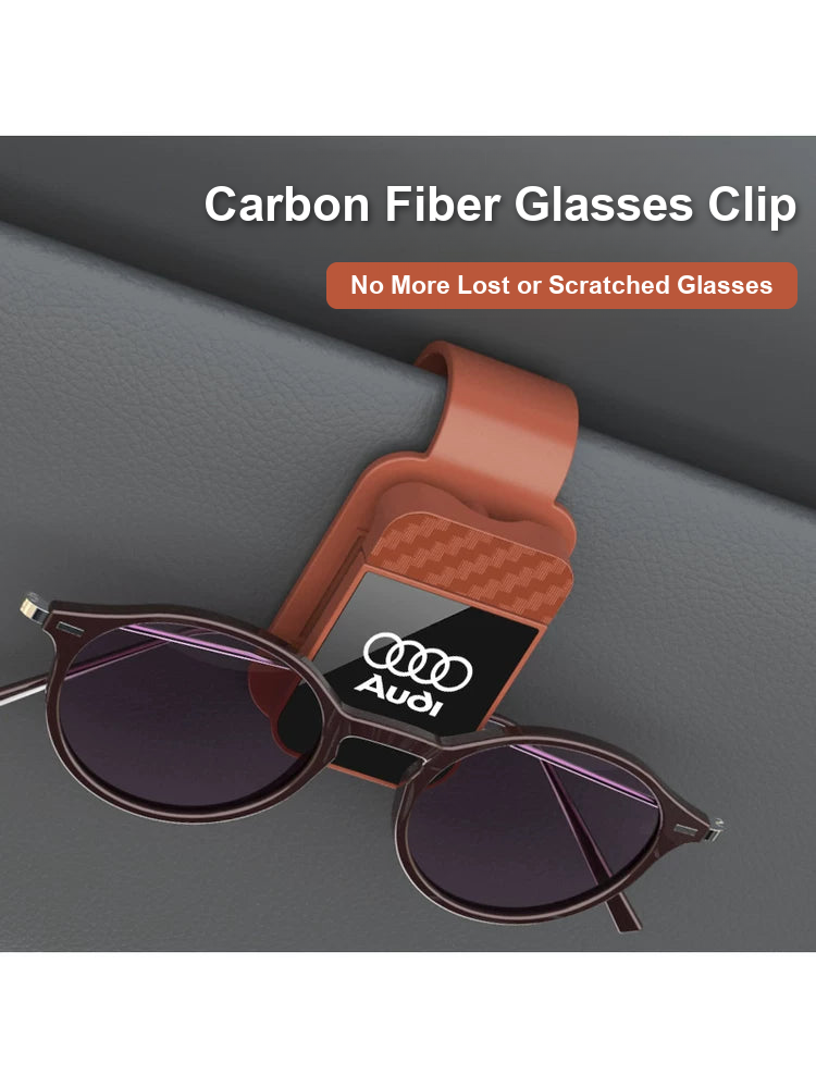 Audi carbon fiber glasses clip in brown holding sunglasses on the visor