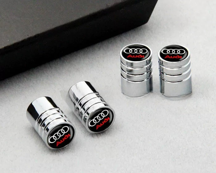 Chrome Audi valve caps with black Four Rings dome and red script