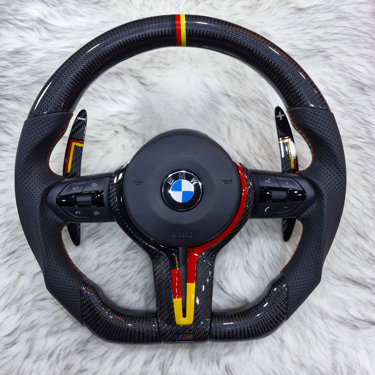Carbon fiber steering wheel with black, red and yellow trim and paddle shifters for BMW F series