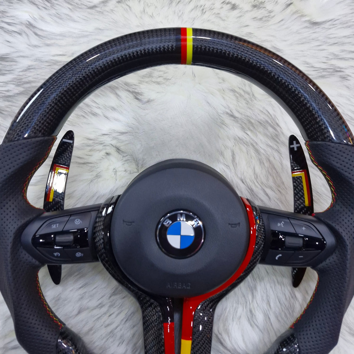 Carbon fiber steering wheel with red and yellow trim for BMW F series - detail view