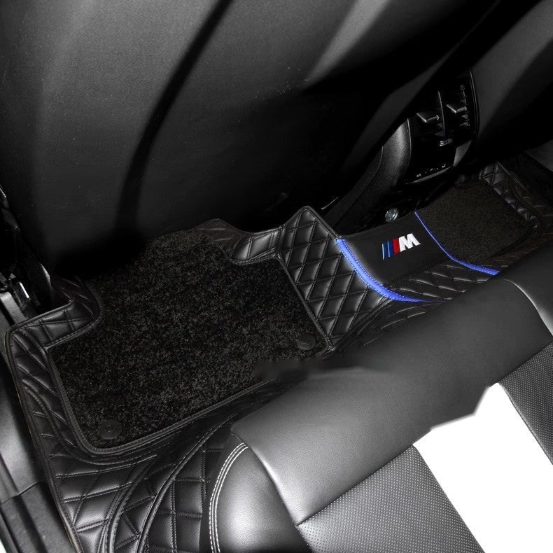 BMW custom floor mat installed in car with M badge detail