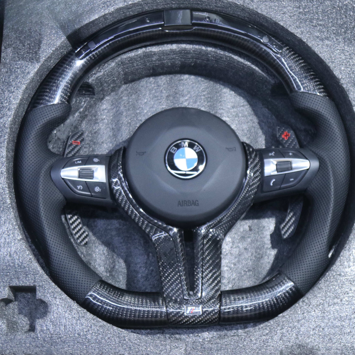 BMW F-Series carbon fiber LED steering wheel with carbon paddle shifters in protective foam box