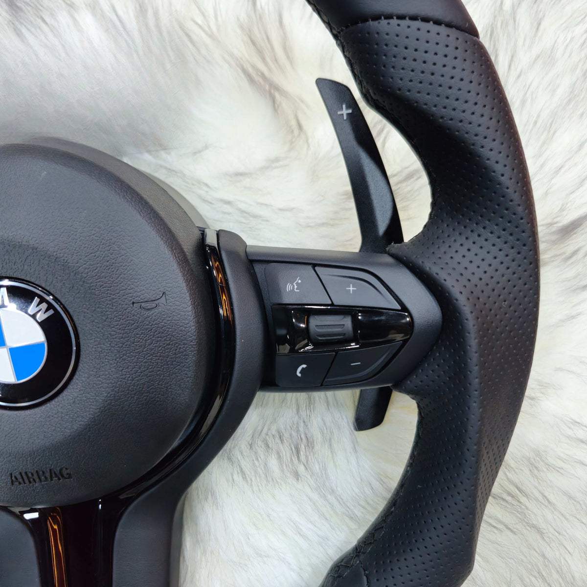 Multifunction buttons and paddle shifter on the BMW F-Series Nappa leather steering wheel
