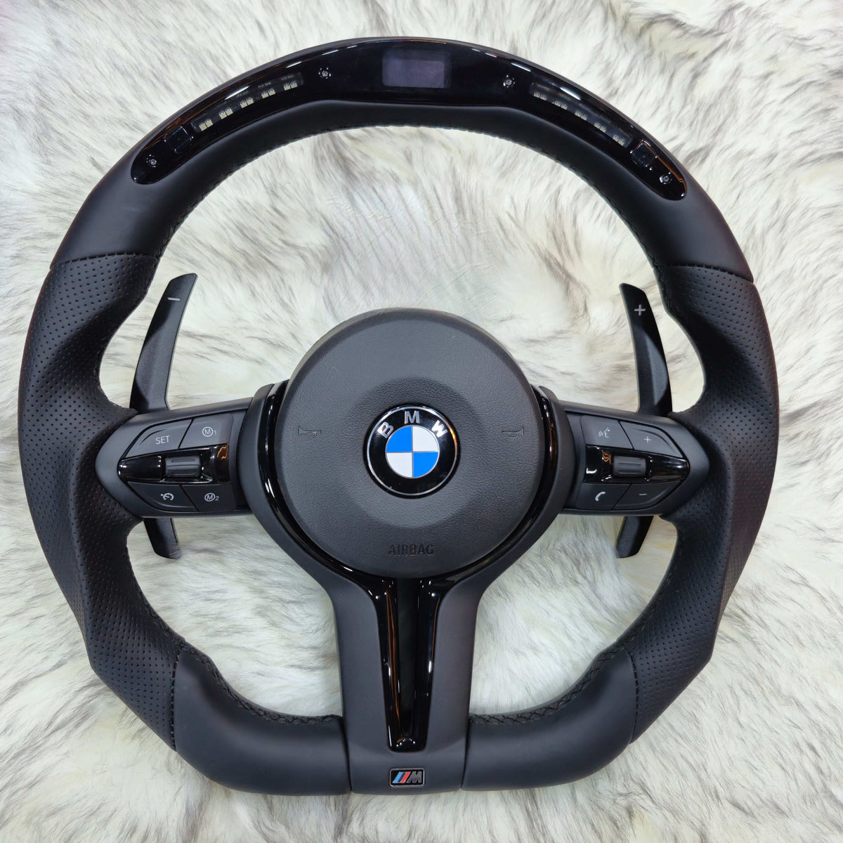 Perforated Nappa leather BMW F-Series steering wheel with black trim and LED display, front view
