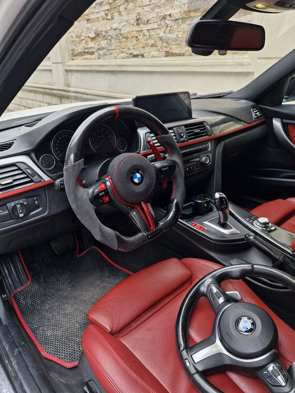 BMW F Series Alcantara red carbon trim steering wheel installed in car