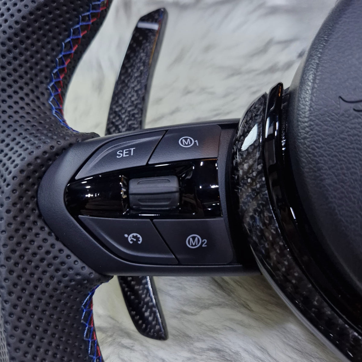 All black M Performance steering wheel for BMW F series - multifunction buttons close-up