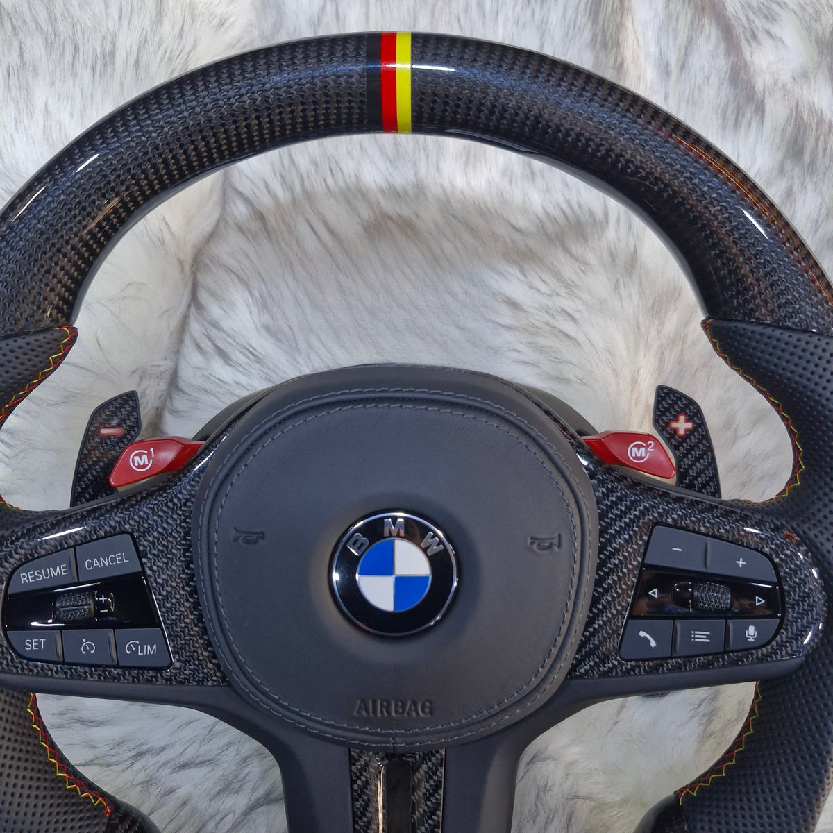 BMW G series carbon fiber steering wheel with custom trim and paddle shifters