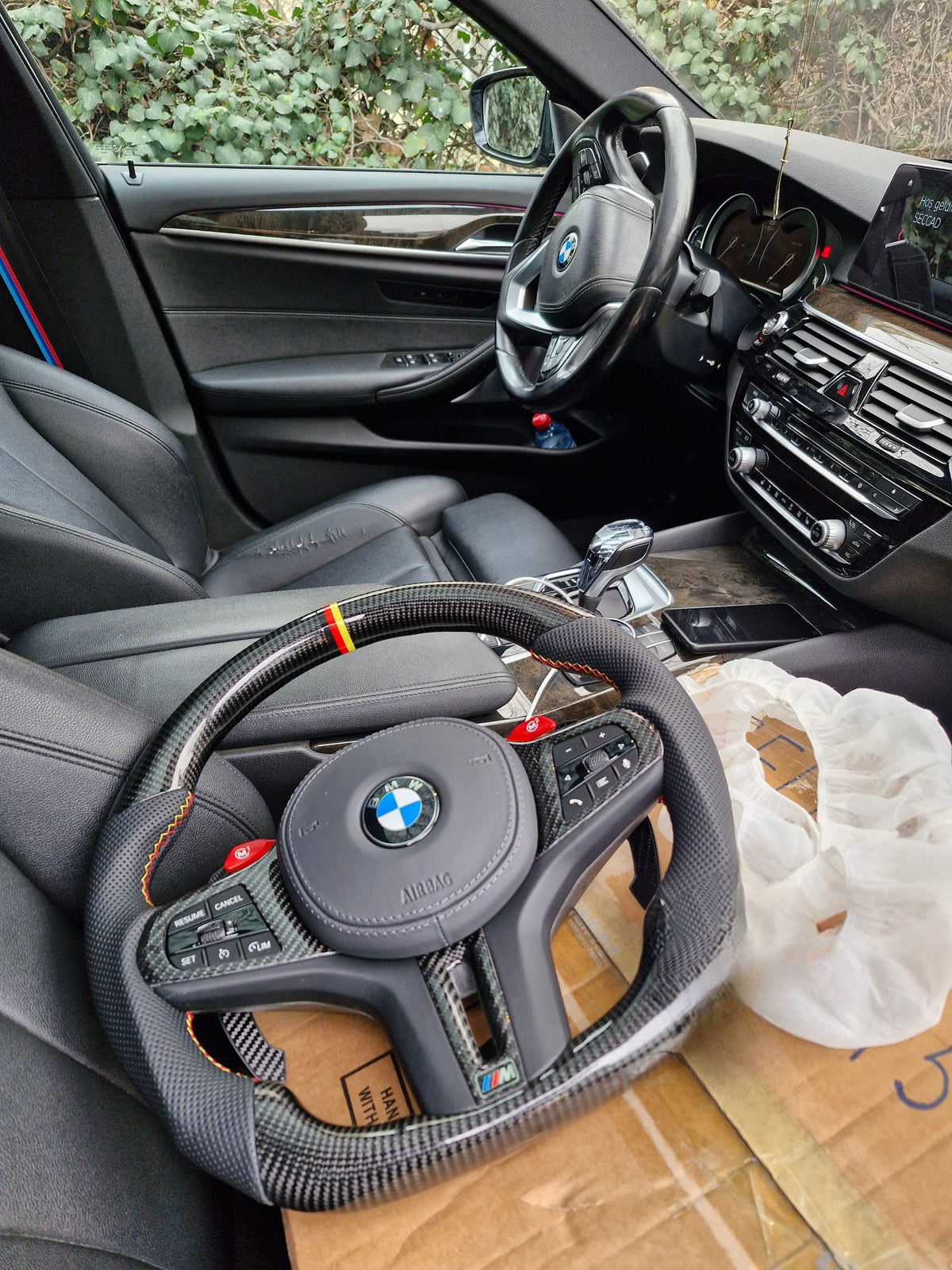 BMW G series carbon fiber steering wheel with paddle shifters - in-car view