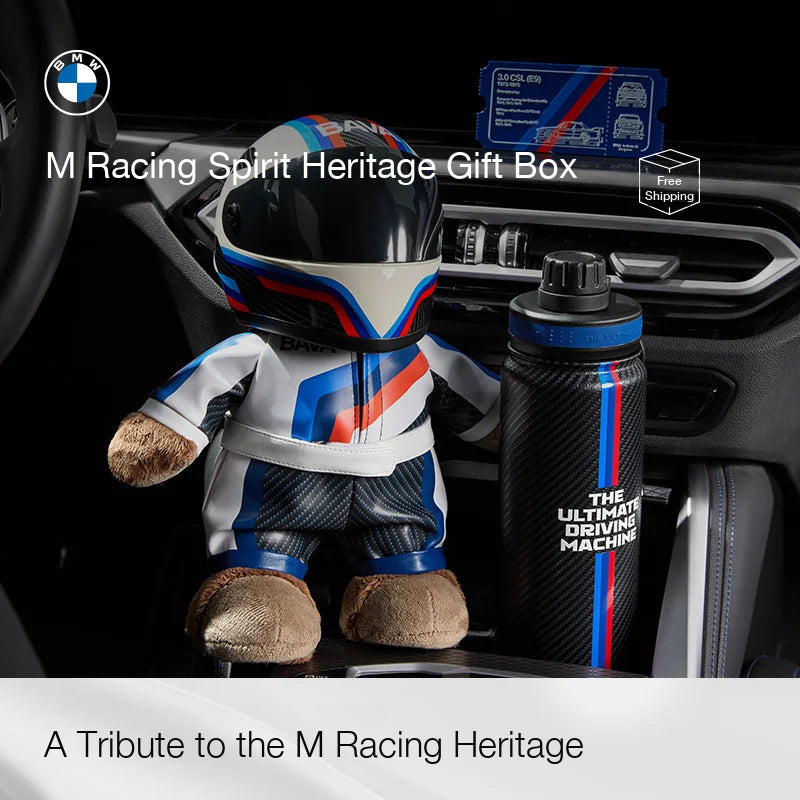 BMW M racer bear in M stripe racing suit and helmet next to The Ultimate Driving Machine bottle
