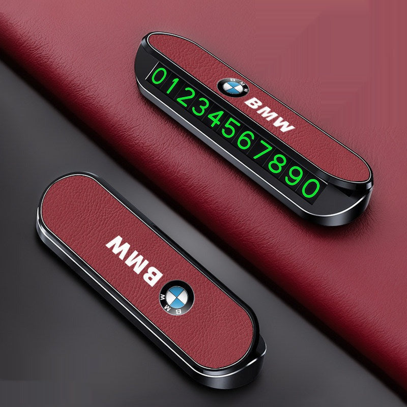 BMW LED temporary parking number plate on red car dashboard, glowing green digits