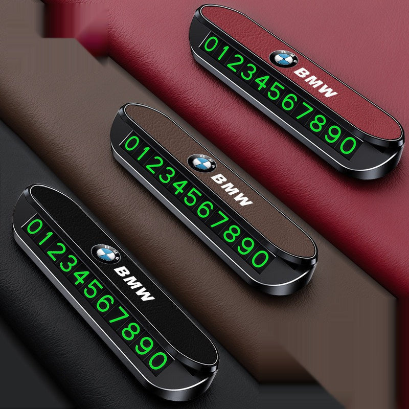BMW parking phone number plate in three color variants on dashboard