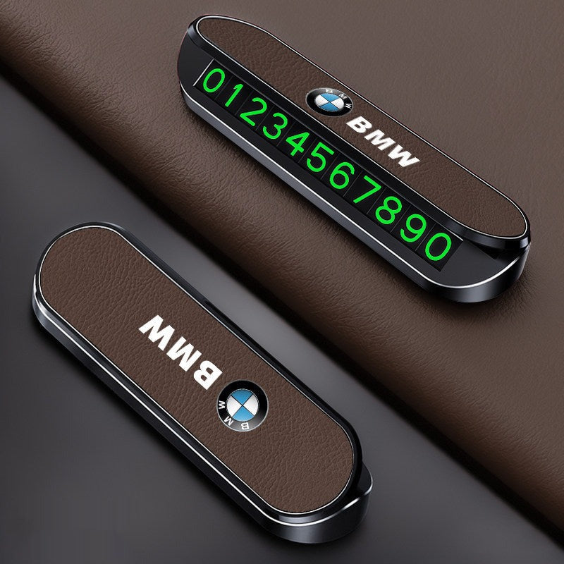 Black BMW LED parking number plate glowing on dark interior