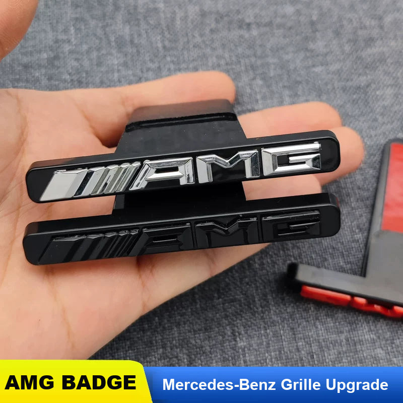 Mercedes-AMG grille badge in chrome and gloss black held in hand