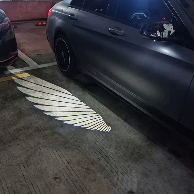 Angel Wings light carpet projected beside a Mercedes-Benz from the side mirror