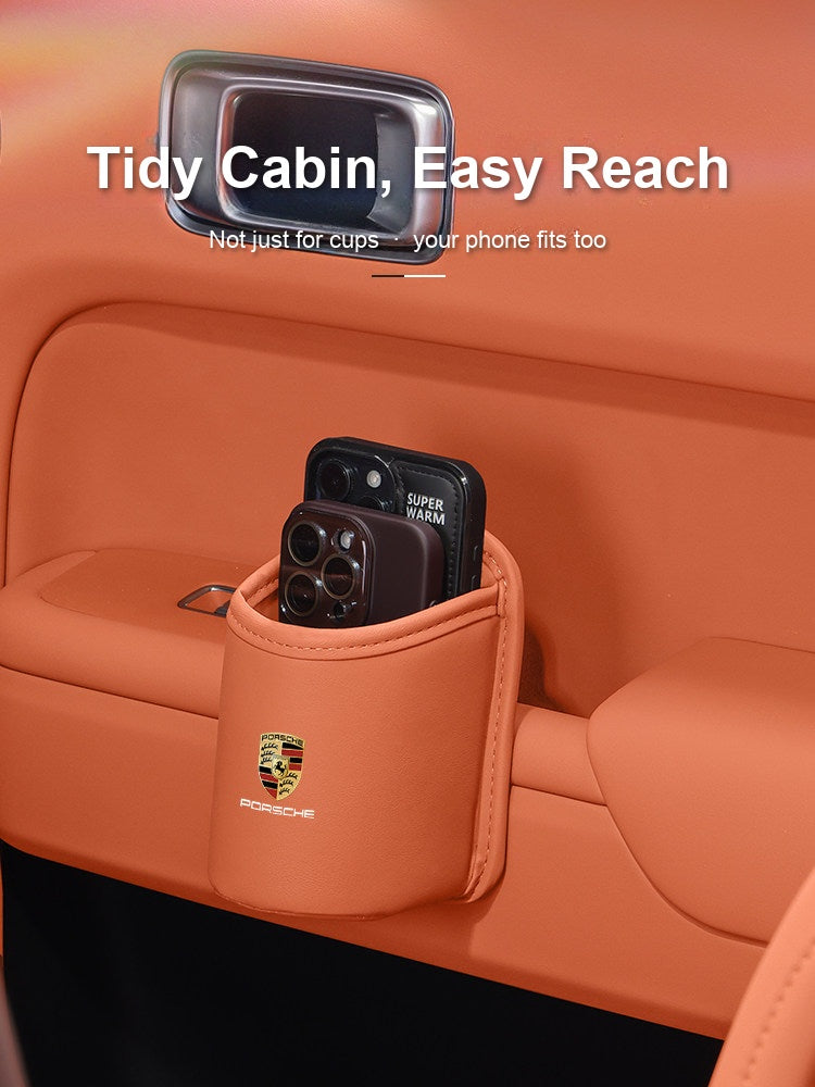 Porsche cup holder storing phones on the door panel