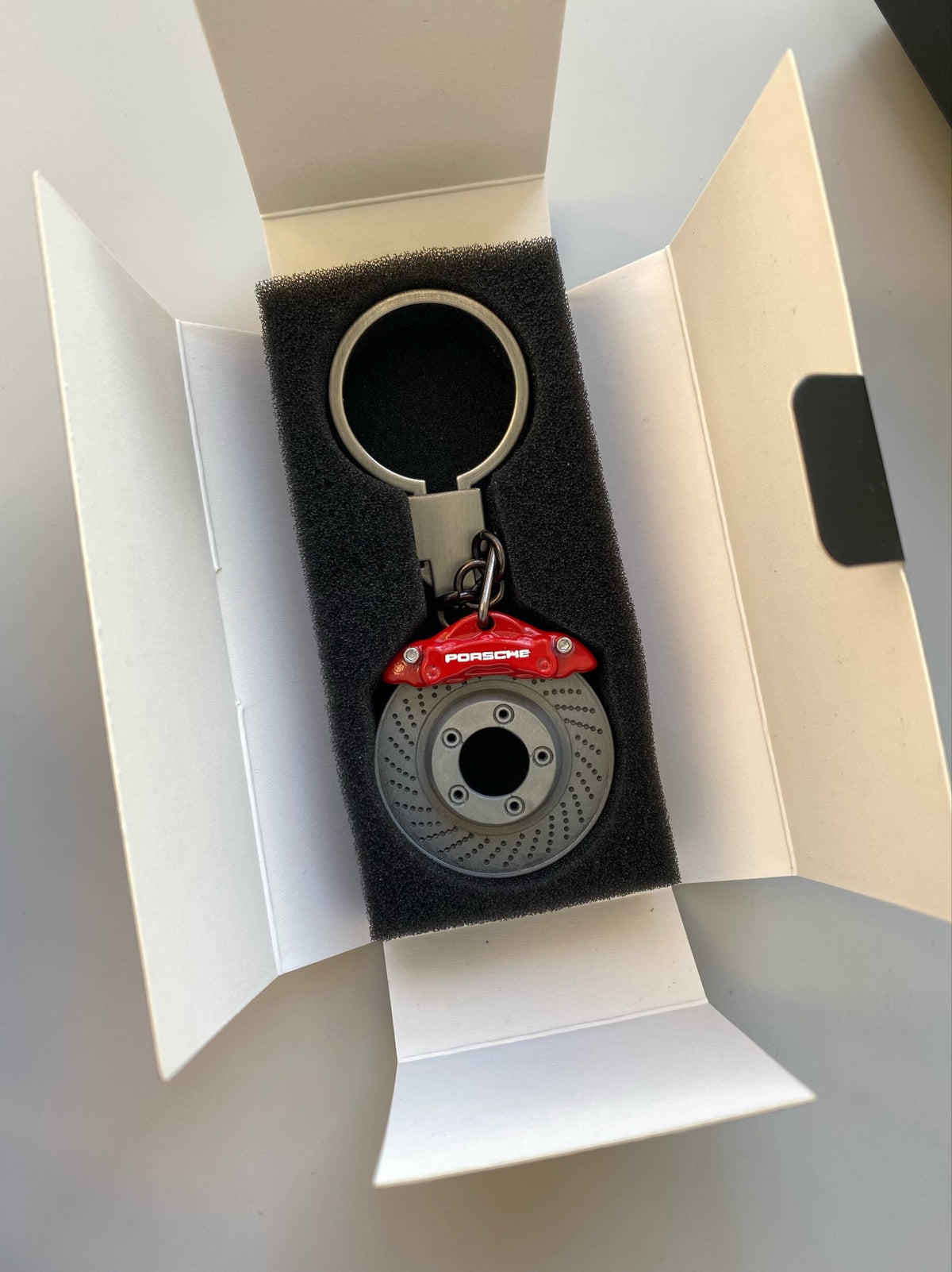 Porsche brake disc keychain with red caliper in gift box