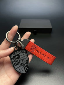 Porsche Carbon Fiber Crest Keychain – Real Carbon Shield with Suede Key Strap for Cayenne, Macan, Panamera, 911 and 718