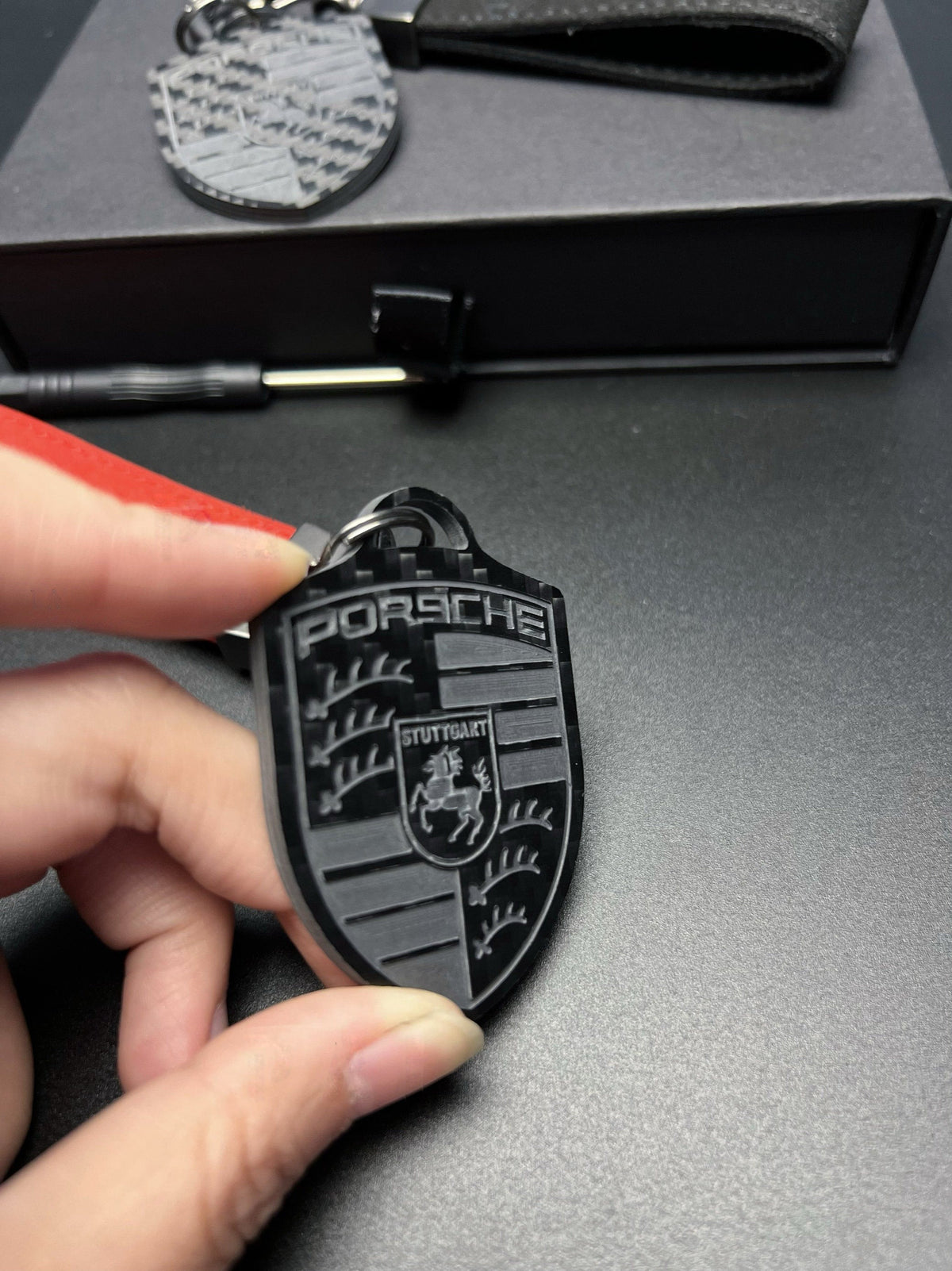 Porsche carbon fiber crest keychain close-up