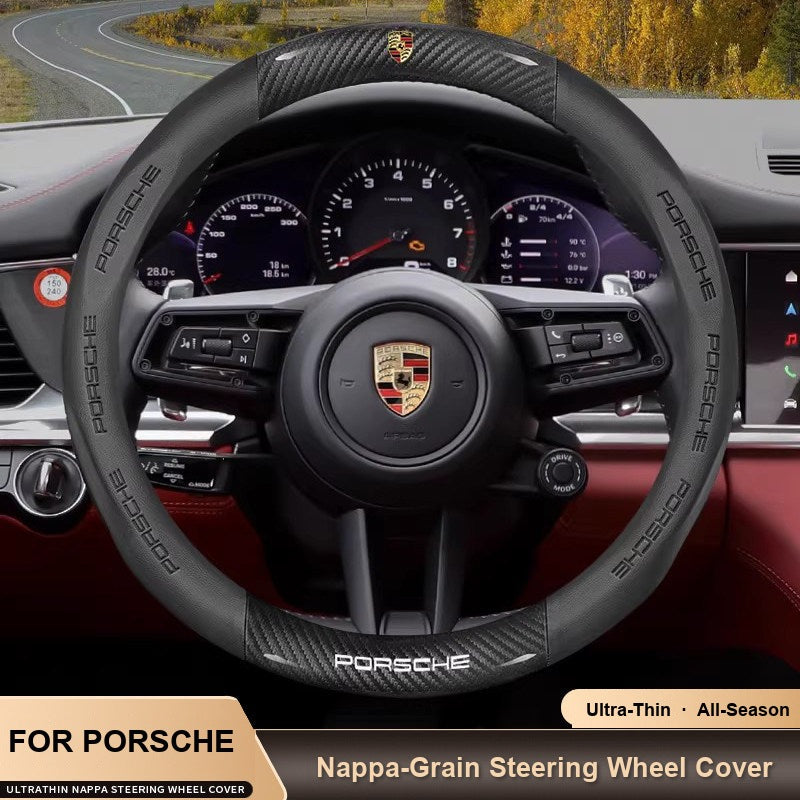 Porsche steering wheel cover – carbon fiber and black perforated leather-look grip on a Porsche wheel